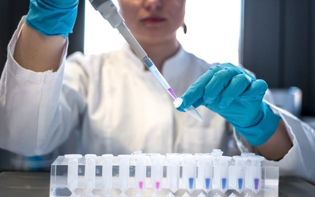 Scientist using a pipette with laboratory tubes
